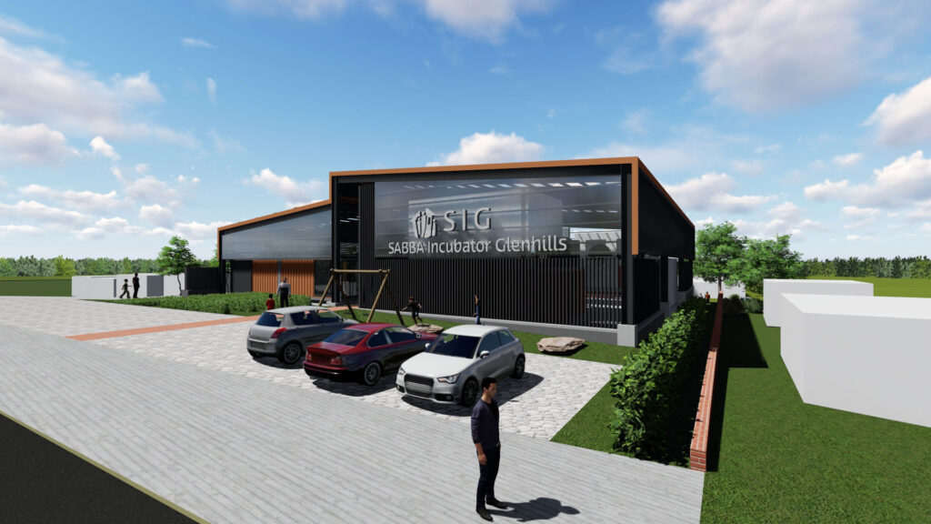 Exterior view of a modern industrial complex entrance with a dark-colored building, large glass sections, multiple parked cars, and a landscaped barrier